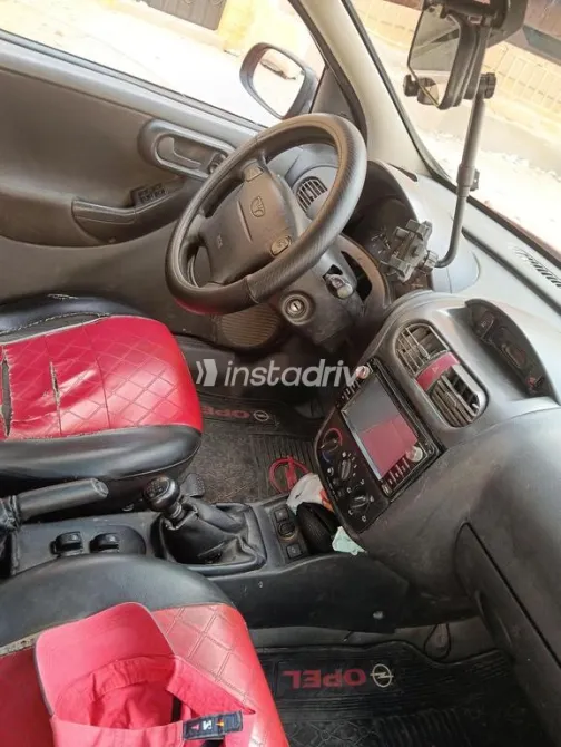 اوبل كورسا 2003 أحمر مستعملة للبيع - 1