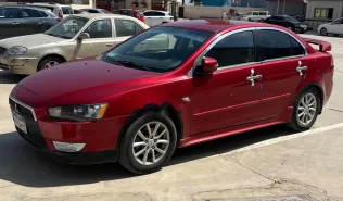 ميتسوبيشي لانسر اى اكس شارك 2015 أحمر غامق مستعملة للبيع