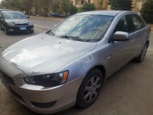 ميتسوبيشي لانسر اى اكس شارك 2014 ذهبي مستعملة للبيع