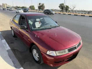 ميتسوبيشي لانسر كرستالة 1999 أحمر غامق مستعملة للبيع