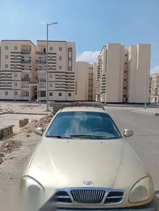 دايو لانوس 2004 ذهبي مستعملة للبيع