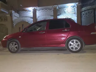 ميتسوبيشي لانسر بومة 2009 أبيض مستعملة للبيع