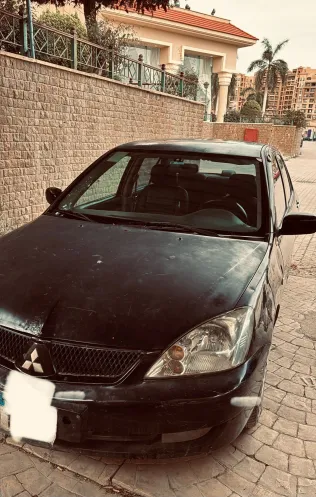 ميتسوبيشي لانسر 2009 أبيض مستعملة للبيع