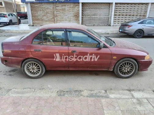 ميتسوبيشي ميراج 1999 أحمر غامق مستعملة للبيع - 1