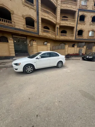 ميتسوبيشي لانسر 2015 أبيض مستعملة للبيع