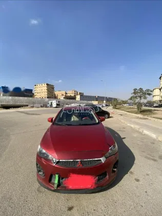 ميتسوبيشي لانسر اى اكس شارك 2016 أحمر غامق مستعملة للبيع