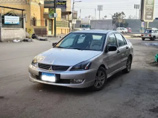 ميتسوبيشي لانسر بومة 2010 ذهبي مستعملة للبيع