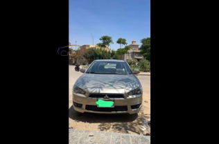 ميتسوبيشي لانسر 2009 ذهبي أوتوماتيك مستعملة للبيع في مدينة الشيخ زايد