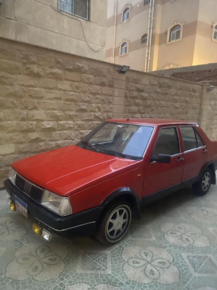 فيات ريجاتا 1990 أحمر أوتوماتيك مستعملة للبيع في مدينة الشيخ زايد