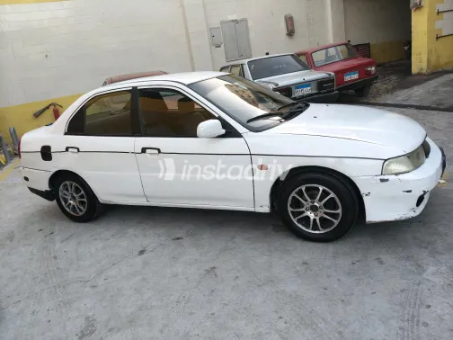 Mitsubishi Mirage 1999 White Manual Used for Sale in Greater Cairo ( Cairo + Giza) - 7